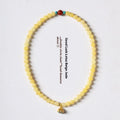 Handmade yellow jade double ring bracelet for women on a wrist, showing 6mm and 8mm size options.