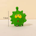 Set of four colourful squeaky dog balls with cute faces on a natural latex rubber texture.