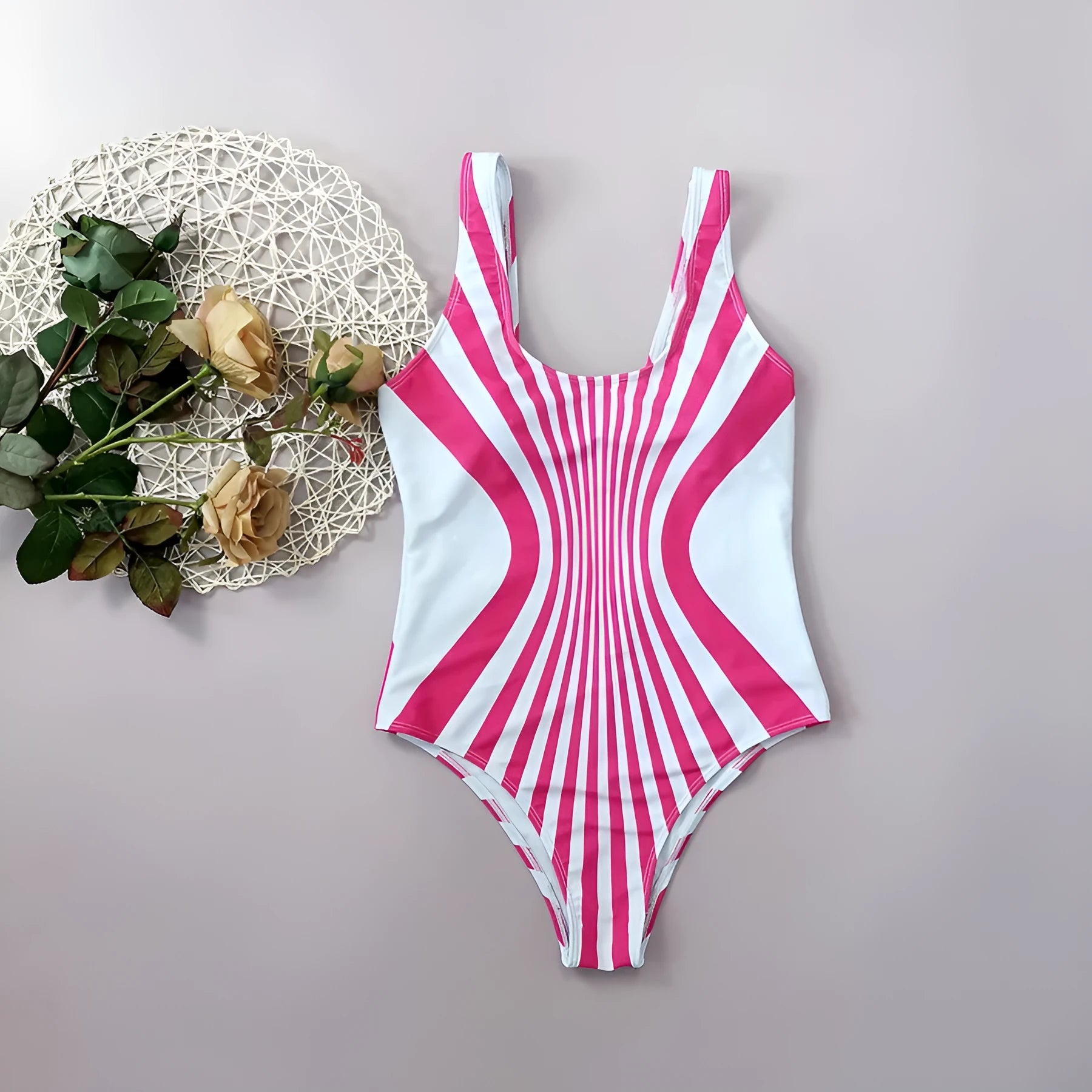 Front and rear view of a pink striped one-piece swimsuit for women on a mannequin