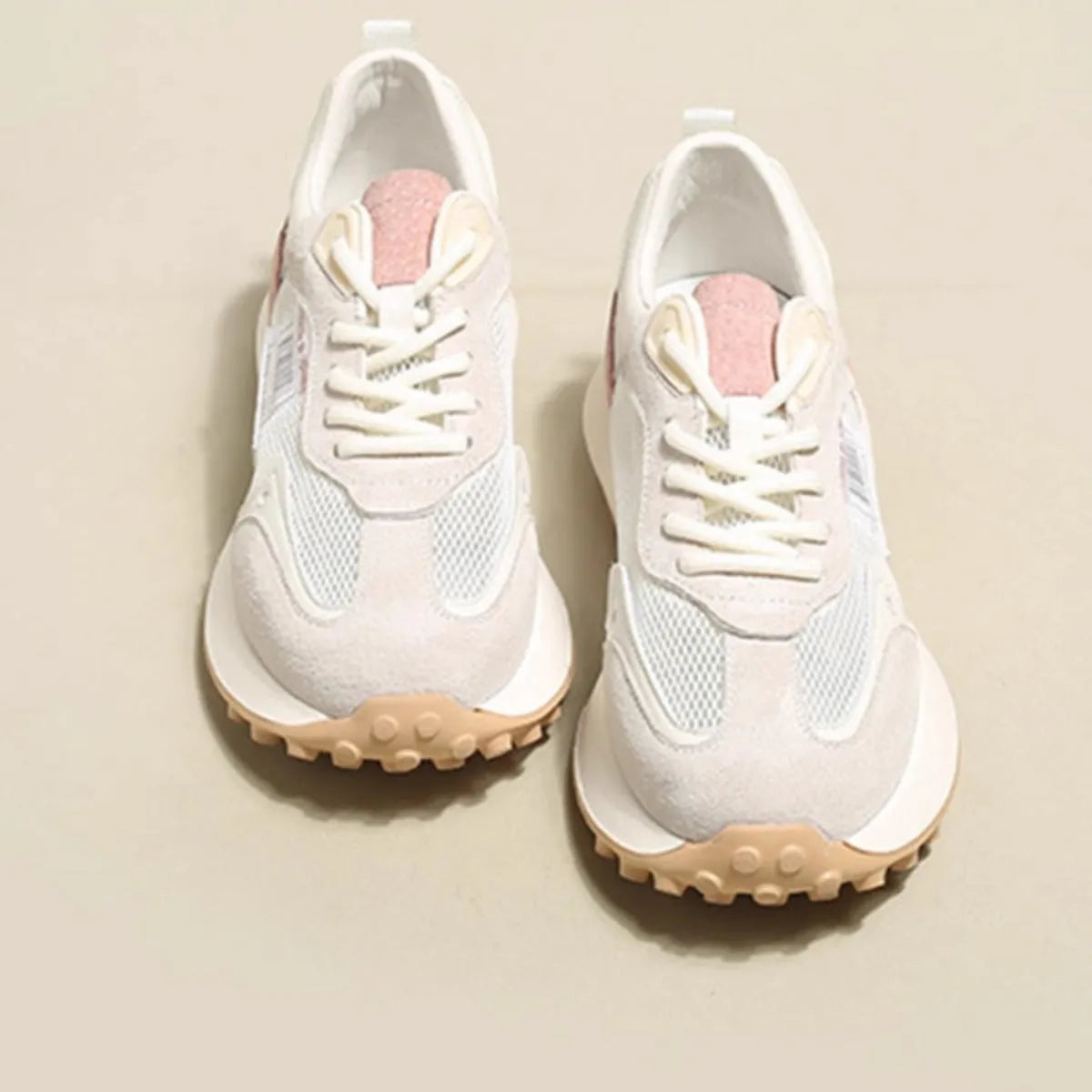 Women's grey and pink retro sneakers with low-top design and rubber soles