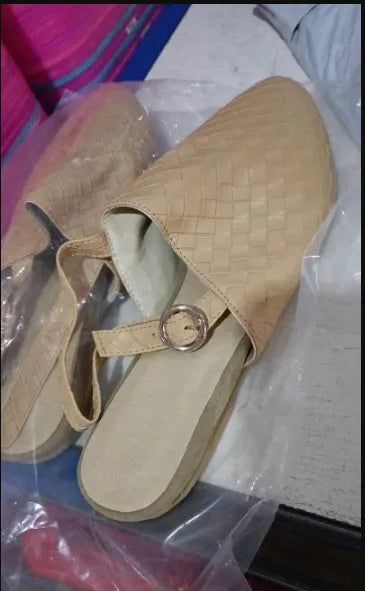 A pair of pointed-toe baotou flat sandals with an adjustable buckle strap, shown in a dark brown colour.