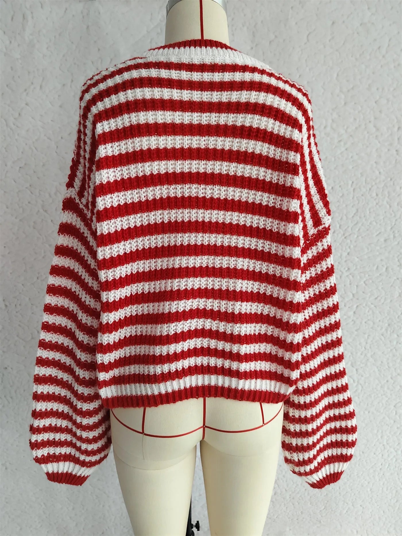 Woman wearing a vintage stripe pattern, loose-fit, long-sleeve pullover sweater.