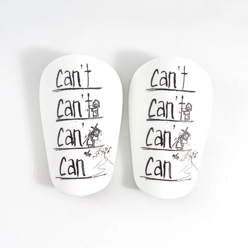 PU material football shin guards in white, black, white and black, and blue colours for training protection