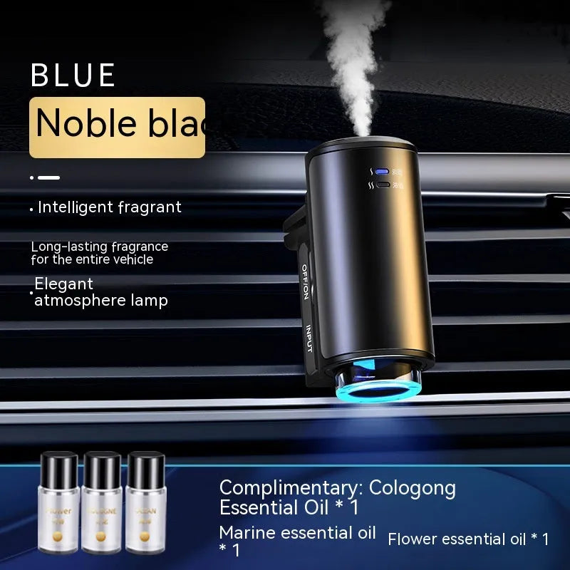 Obsidian black car aroma diffuser clipped to vehicle air vent with essential oil bottles