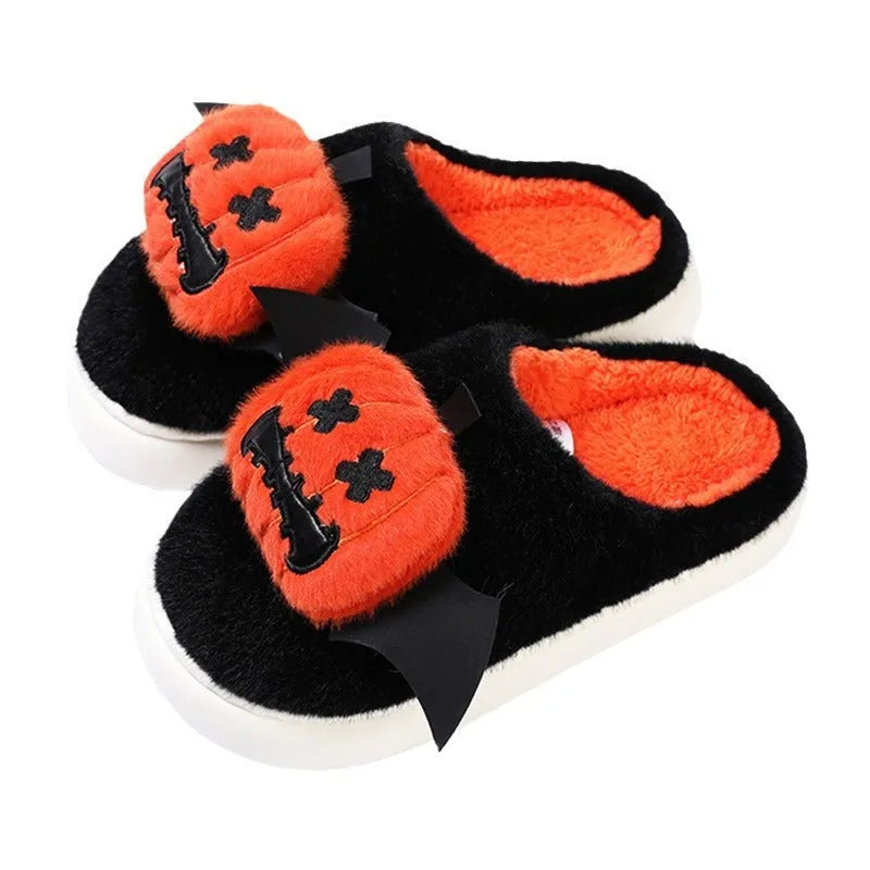 Black Halloween cartoon pumpkin slippers with small wings design on indoor floor
