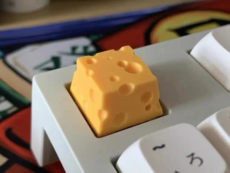 Yellow solid resin cheese wedge keycap for MX mechanical keyboards.