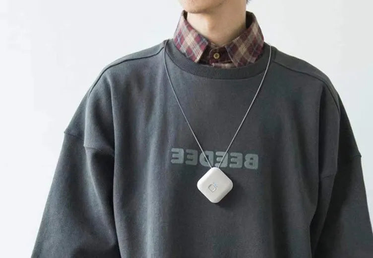 Compact USB-powered air purifier necklace in pink, showing wearable design and one-button control.