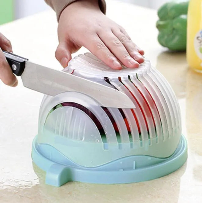 Blue salad cutter bowl showing removable cutting lid placed on a base with a raised rim.