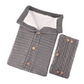Baby sleeping bag in beige with lamb wool and acrylic material, button opening, and matching gloves on pram