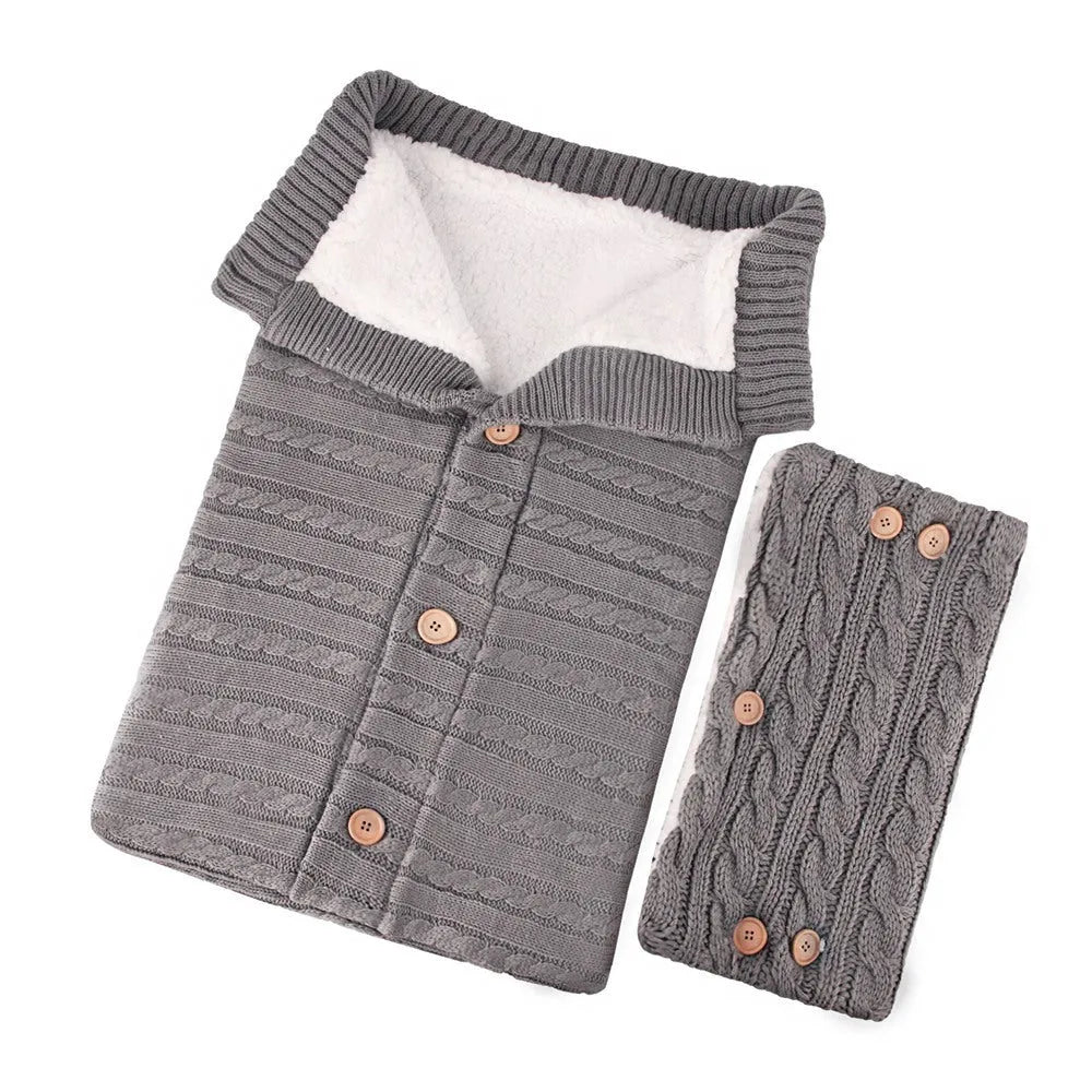 Baby sleeping bag in beige with lamb wool and acrylic material, button opening, and matching gloves on pram