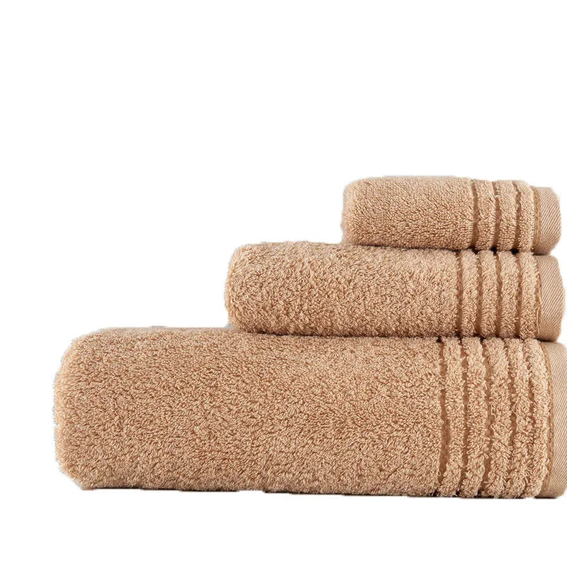 Beige and brown cotton towel set showing bath towel, hand towel, and face cloth sizes
