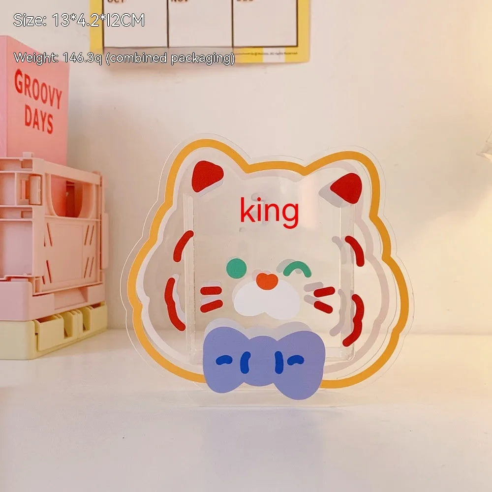 Square transparent acrylic storage box with a cute decorative design, shown on a desk.