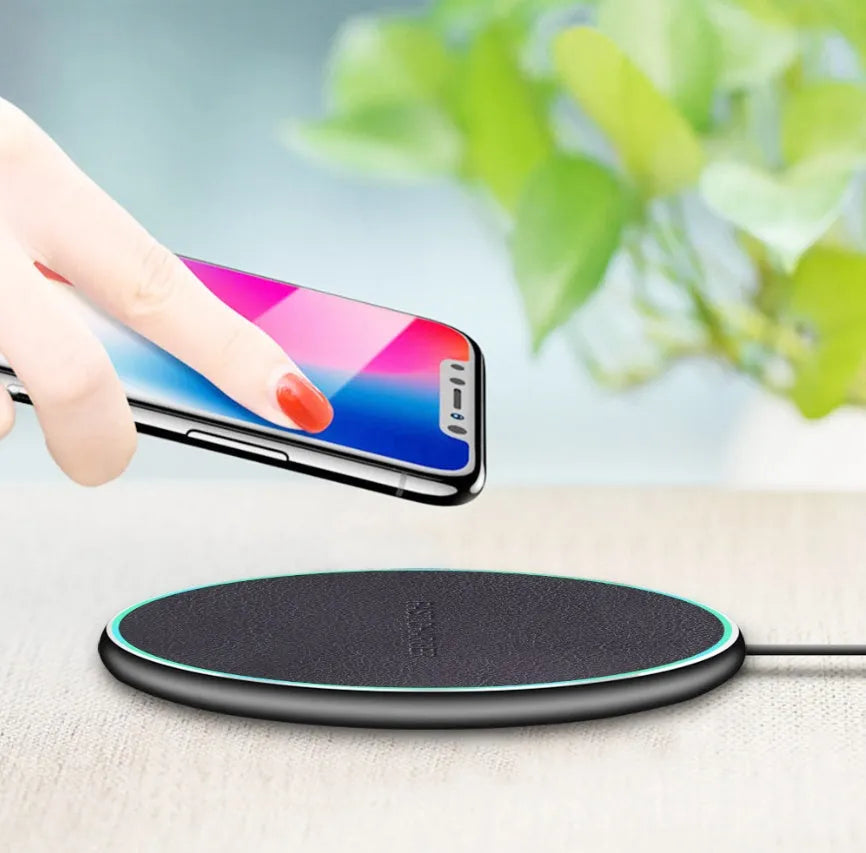 Black Qi wireless charging pad for iPhone 11 showing aluminium casing and silicone charging surface