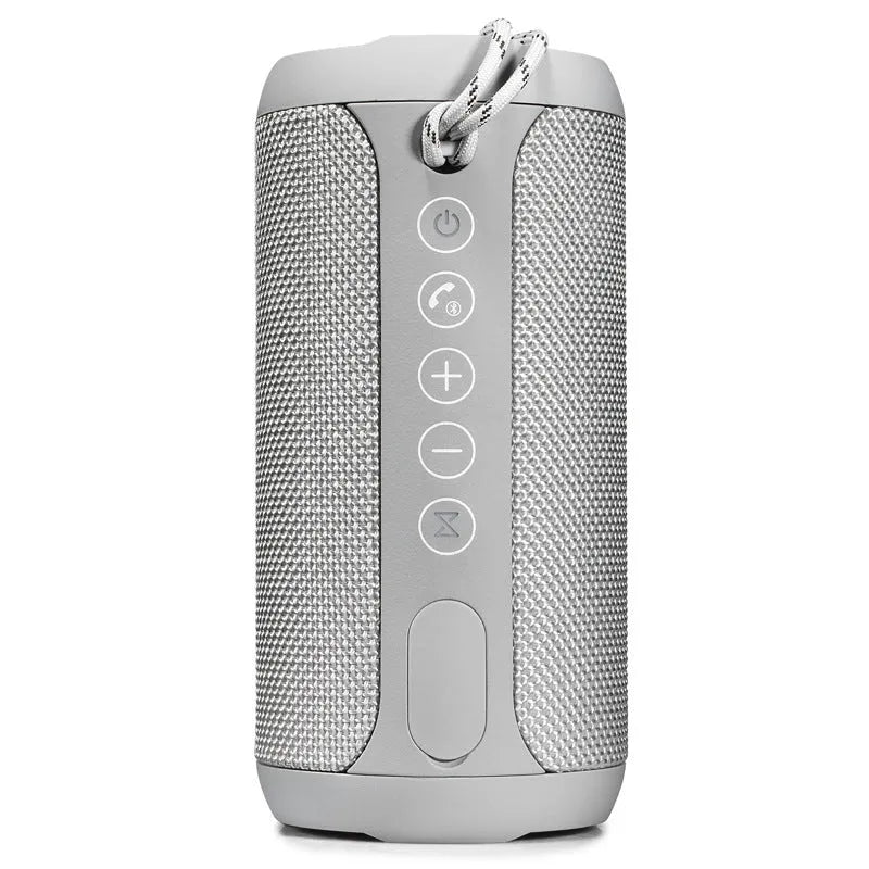 Compact portable outdoor Bluetooth speaker in camouflage finish, placed on a wooden garden table.