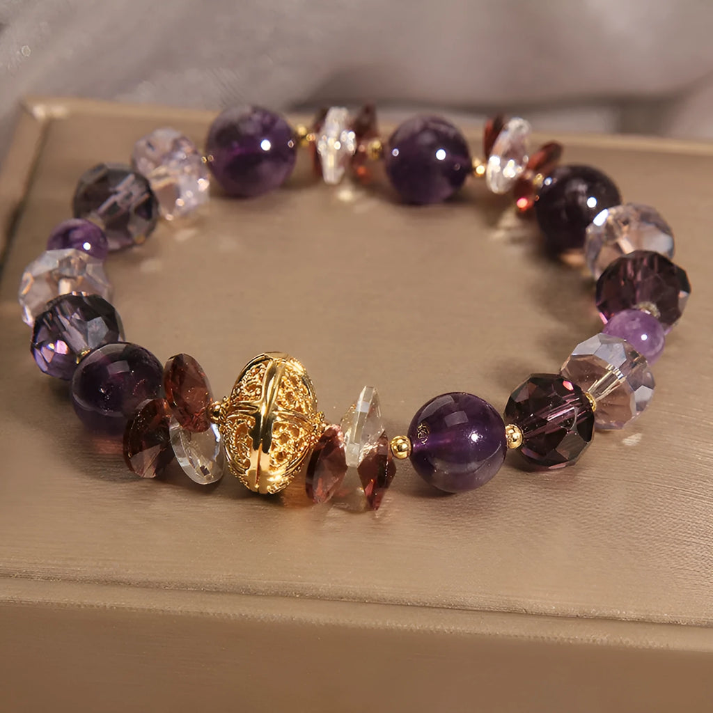 Purple crystal bracelet with pumpkin beads and rhinestone decoration on a wrist.