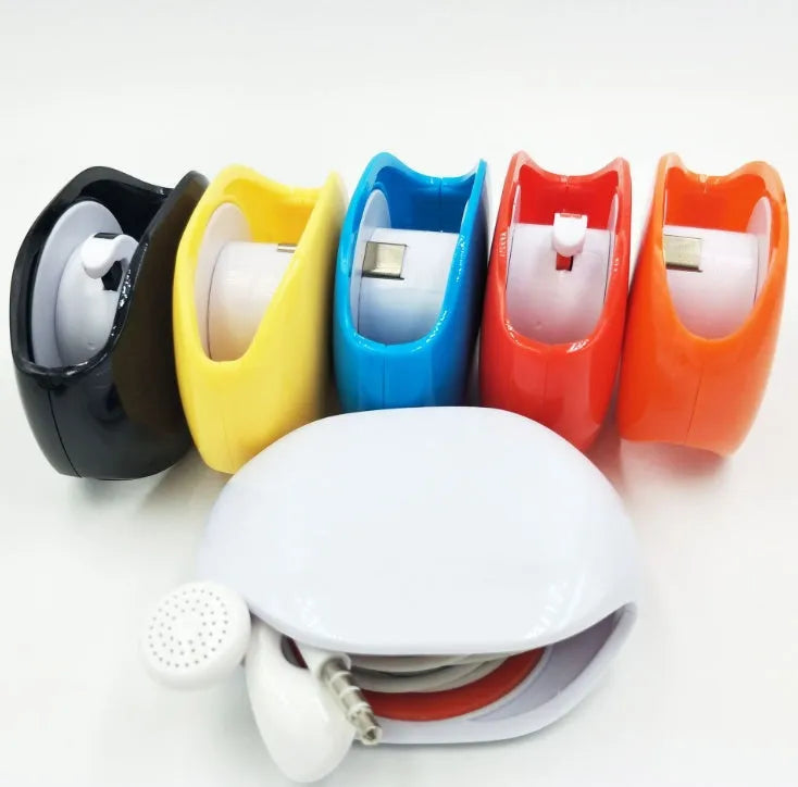 Automatic earphone cable winder unit in blue showing retracted cable, next to a black unit for size comparison.