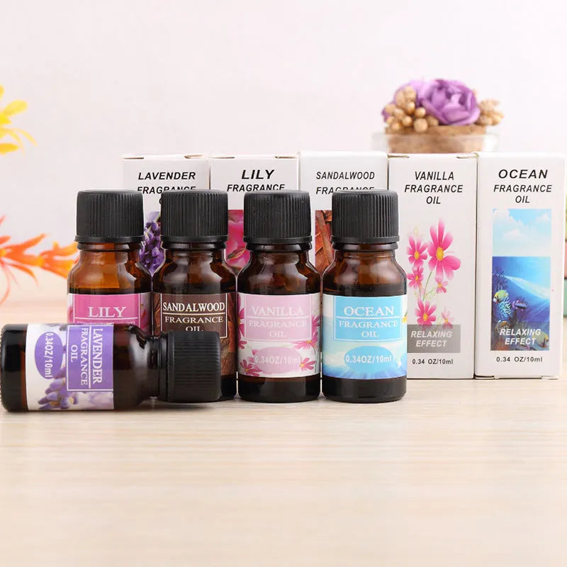 Set of 12 small glass bottles of aromatherapy essential oil, 10ml each, with labels showing Lavender, Rose, Lemon, and other fragrances.