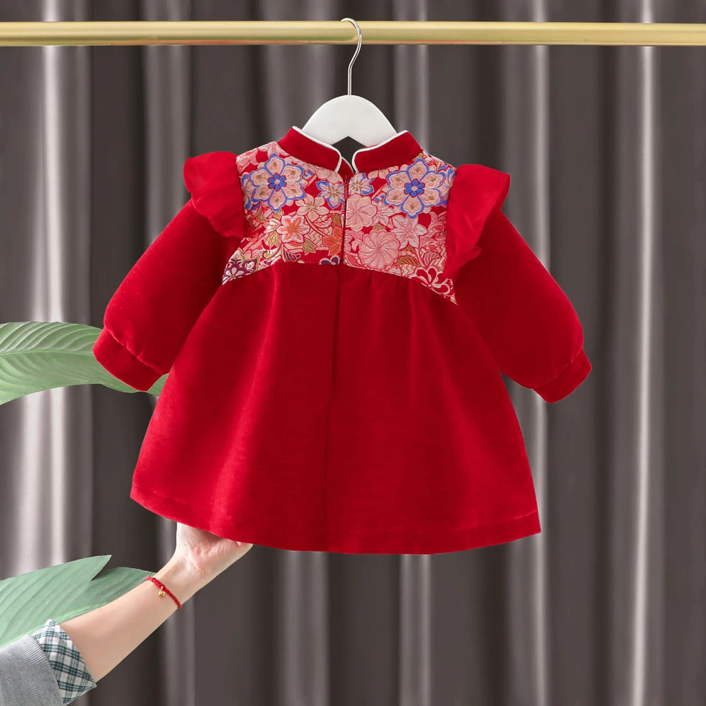 Girls winter velvet padded dress in retro red solid colour with long sleeves, front view on child