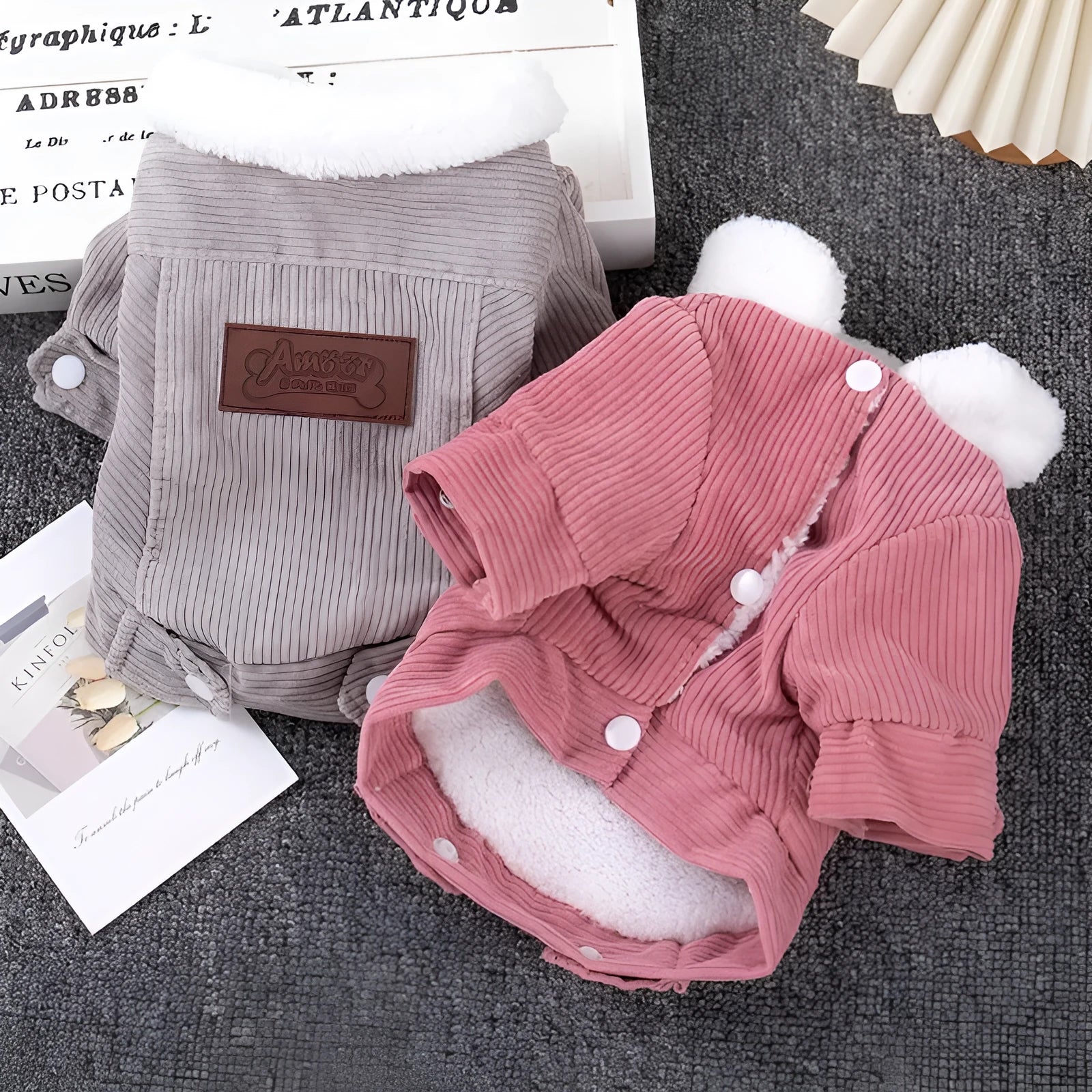 A grey lambswool-lined padded vest for dogs, shown on a mannequin, for winter warmth.