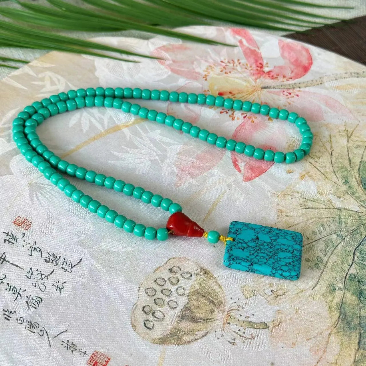 Turquoise stone mesh flower pendant on an adjustable ball bead necklace chain.