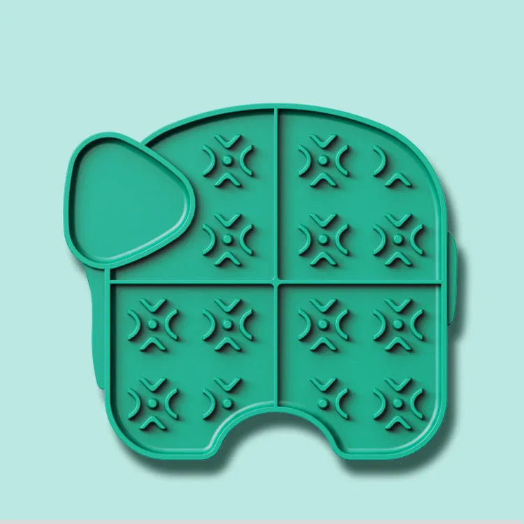 Gray silicone pet slow food pad with suction cups on tile floor, textured surface for licking