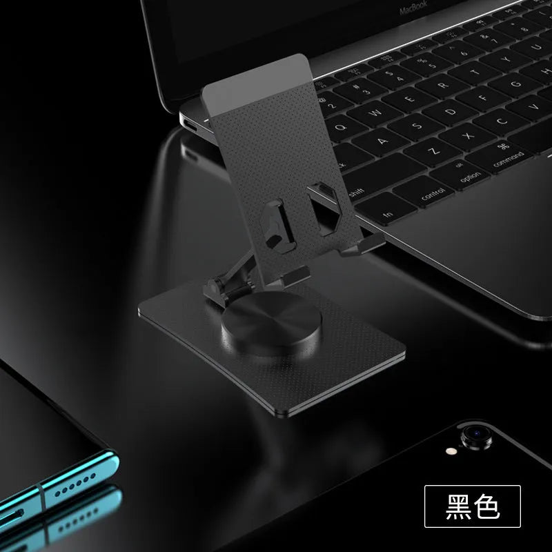 Aluminium alloy rotating mobile phone bracket in silver on a desk, showing three-axis joint and metal texture finish