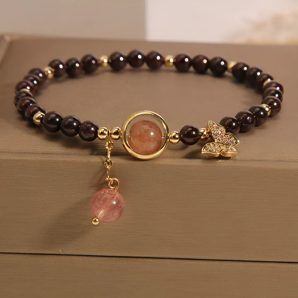 Black butterfly pendant bracelet with stone construction and red rock elements