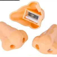 Flesh-coloured plastic manual pencil sharpener with a geometry shape, shown next to a pencil for scale.