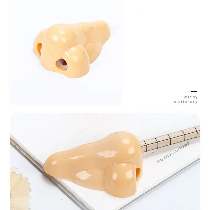 Flesh-coloured plastic manual pencil sharpener with a geometry shape, shown next to a pencil for scale.
