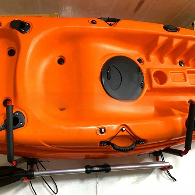 Carbon steel kayak and surfboard wall hanger storage rack mounted on a wall.