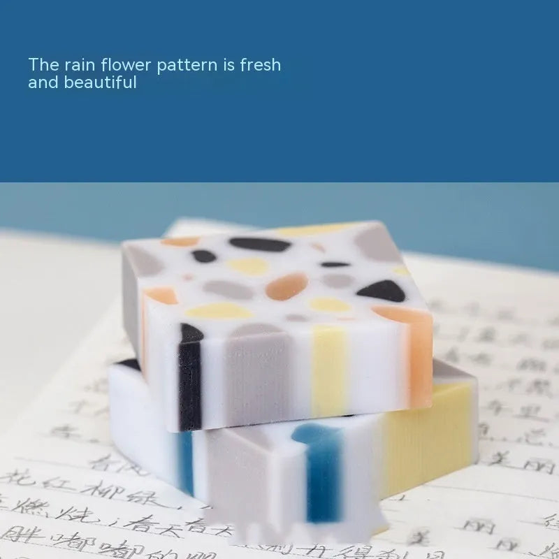 A white brick-shaped soft rubber eraser for traceless pencil correction.