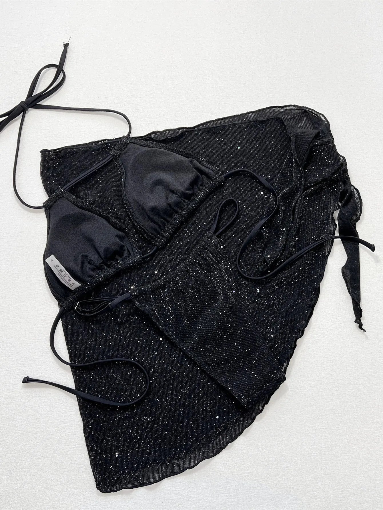 Black women's three-piece bikini set with separate top and shorts on a mannequin.