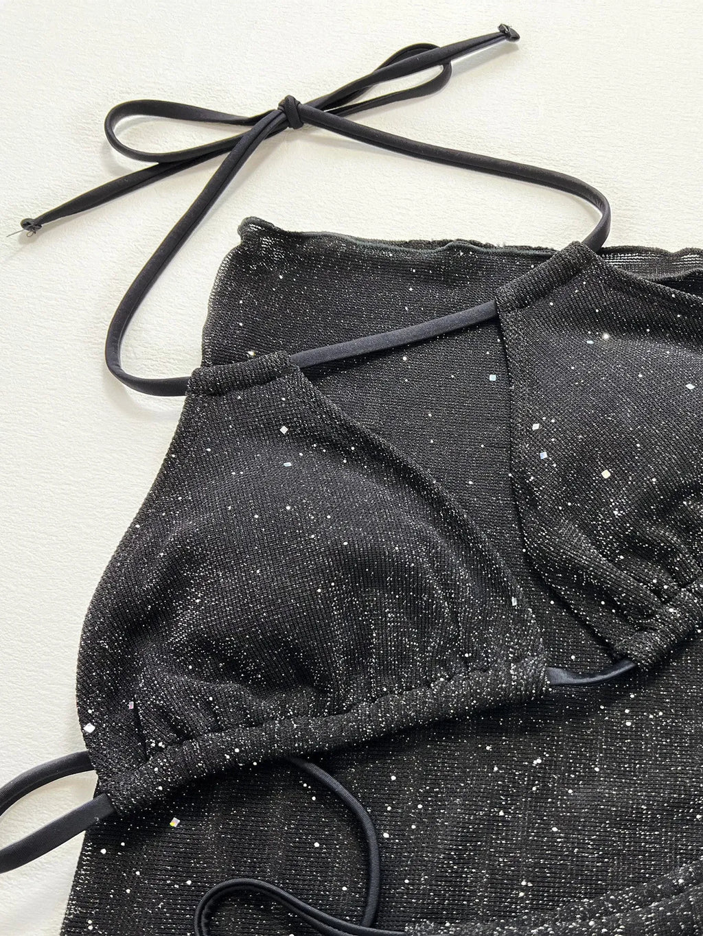 Black women's three-piece bikini set with separate top and shorts on a mannequin.