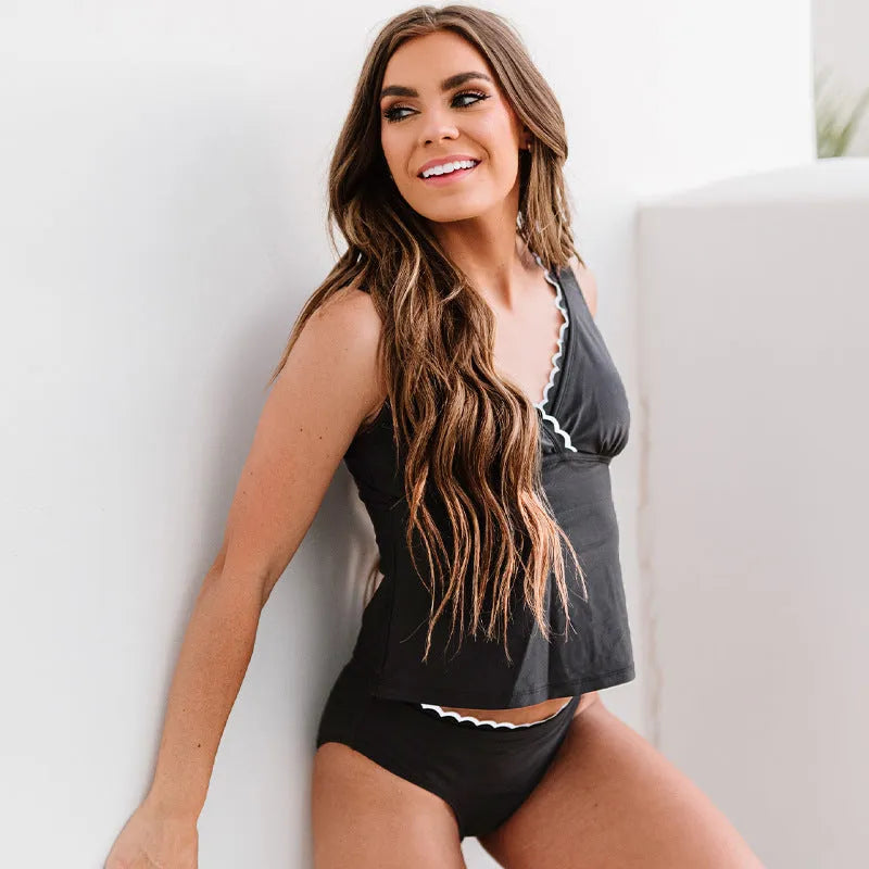 Black solid colour sleeveless women's nylon bikini swimsuit set laid flat.
