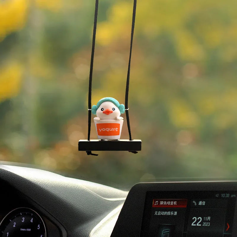 Yellow plastic duck car hanging ornament in four cartoon design styles.