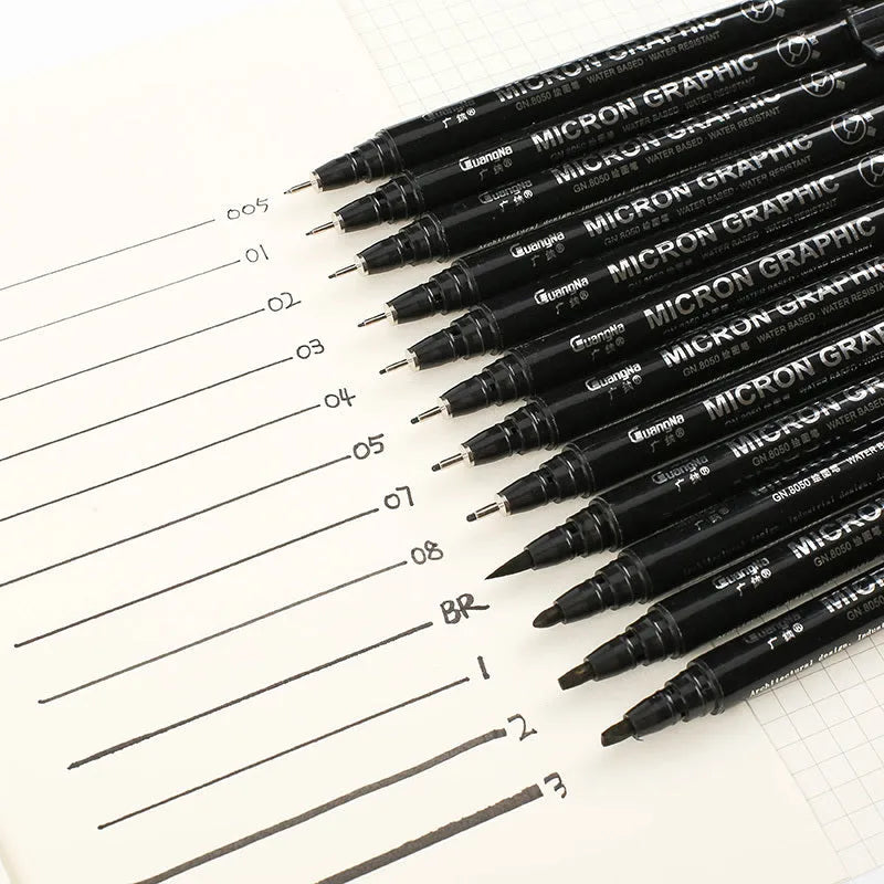 Set of 12 black comic drawing pens with assorted microtip nibs in a fabric organiser pouch.