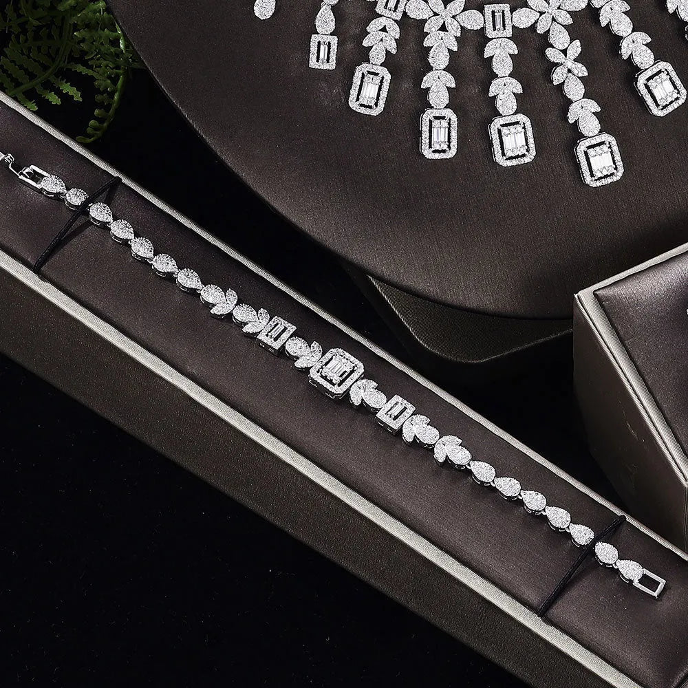 White copper inlaid zircon four piece jewellery set with love heart, water drop, and bell patterns including necklace, earrings, bracelet, and ring