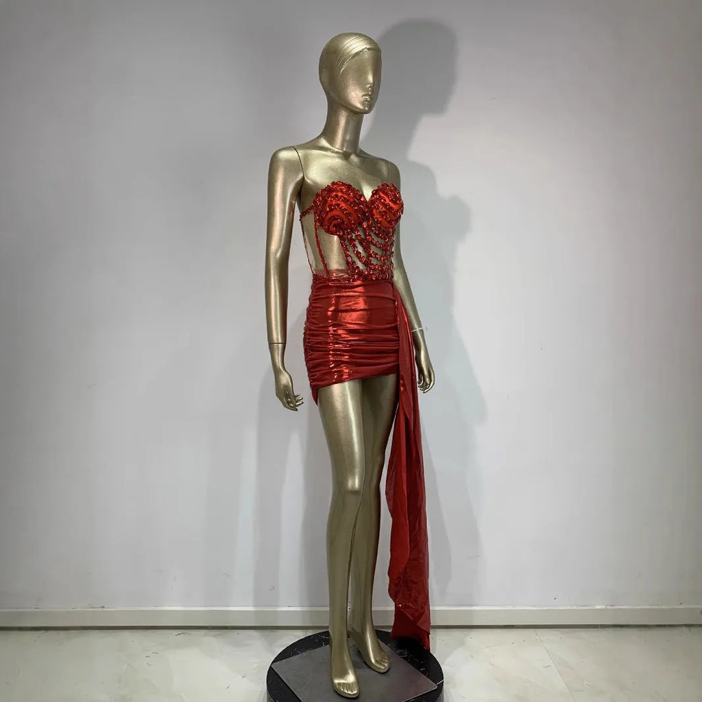 Red two-piece stage costume with hollow mesh panels and a skirt, made from stretch spandex for performers.