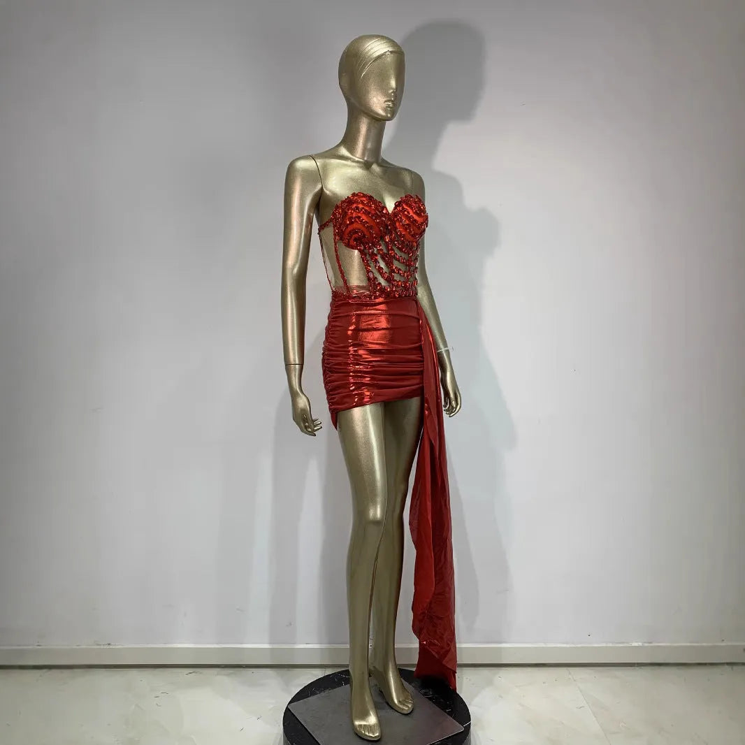 Red two-piece stage costume with hollow mesh panels and a skirt, made from stretch spandex for performers.