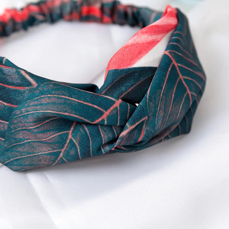 Red cloth headband with woven banana leaf design and cross hair pattern