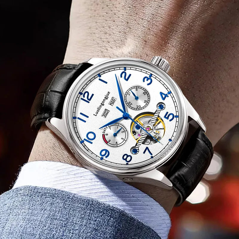 Men's silver stainless steel mechanical watch with white dial and brown leather strap.