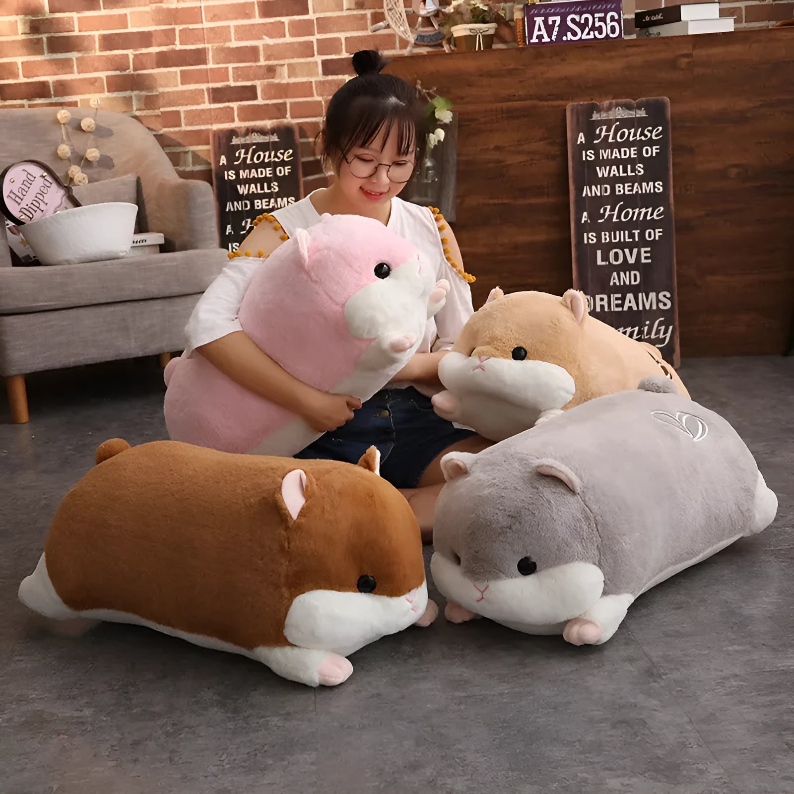Cute hamster pillow made from cotton filled with PP cotton, available in 50cm, 70cm, and 90cm sizes in brown, grey, light brown, and pink.