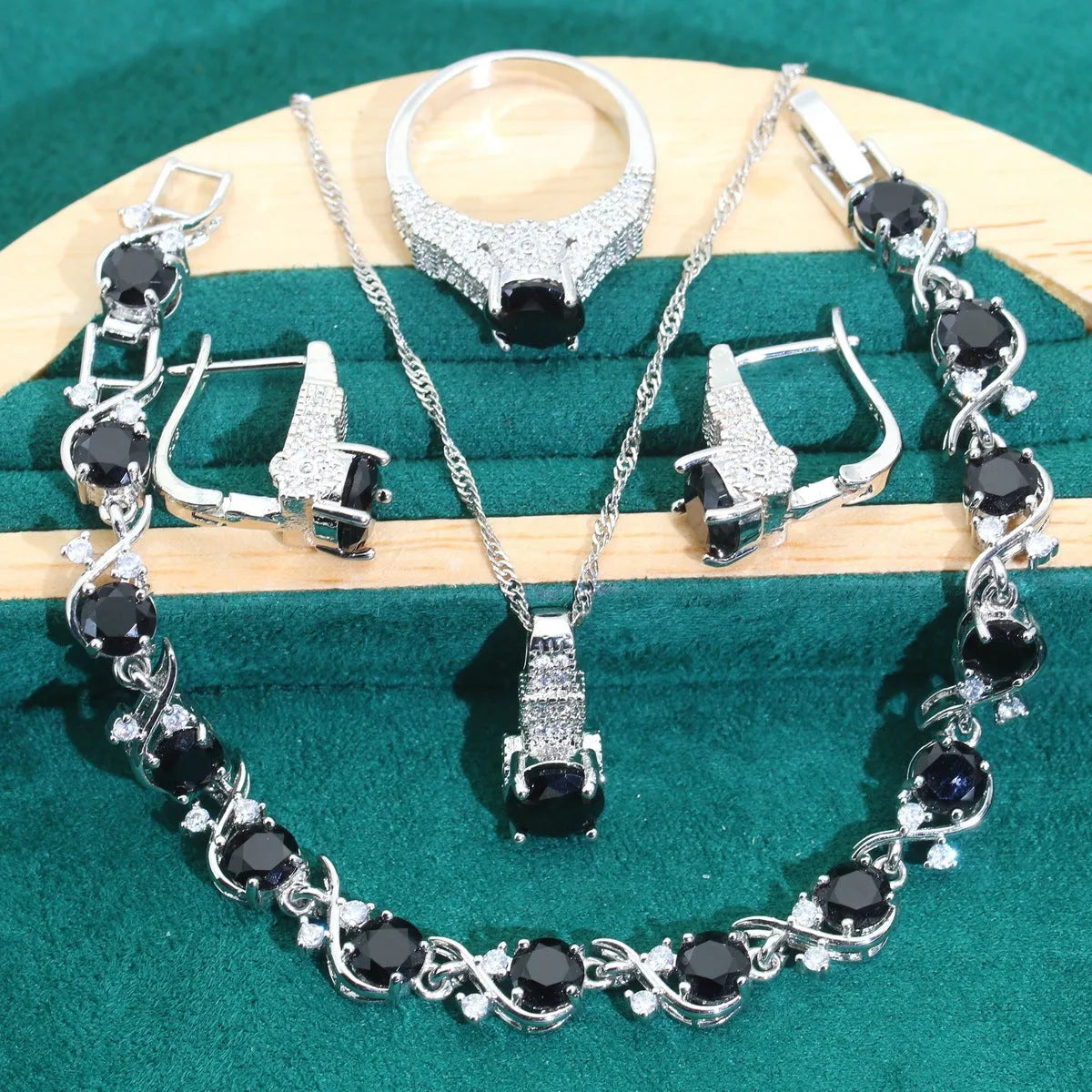 Four-piece bridal jewellery set showing necklace, bracelet, earrings and ring with alloy pendant and water wave chain