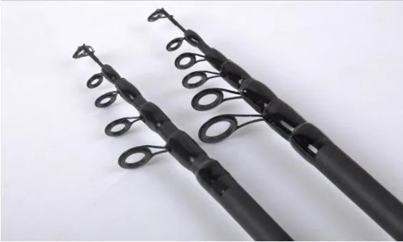 Telescopic carbon fishing rod with matte coating and reel seat on a lakeside bank