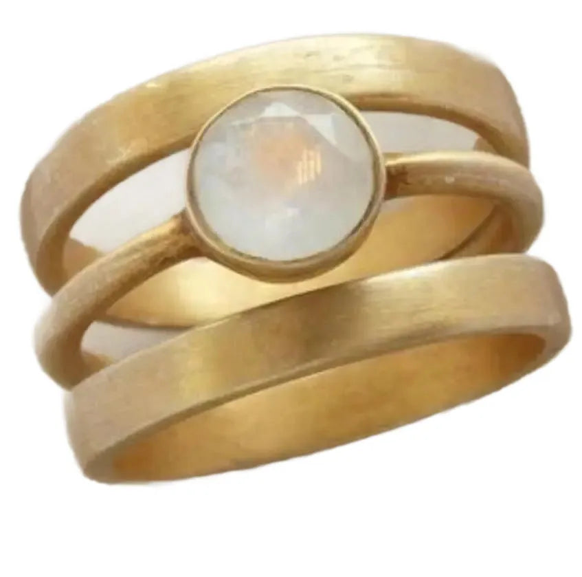 A gold-plated geometric ring with a hollow design and micro-inlaid white chalcedony details.