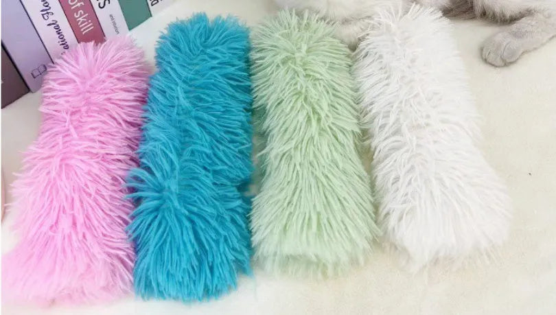 Plush cat toy pillow in green, white, blue, and pink colours measuring 27 by 10 centimetres