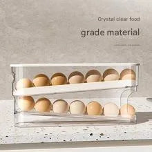 White plastic refrigerator slide-out egg tray with automatic dispenser mounted on refrigerator door