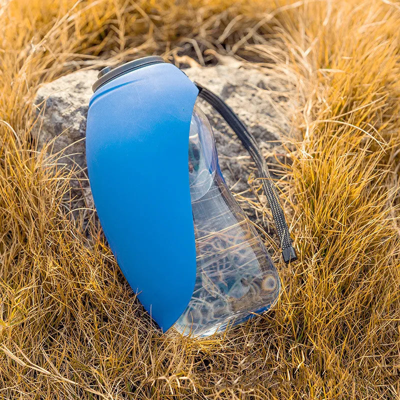 Blue plastic dog water bottle with built-in drinking bowl showing 680ml capacity and key lock mechanism