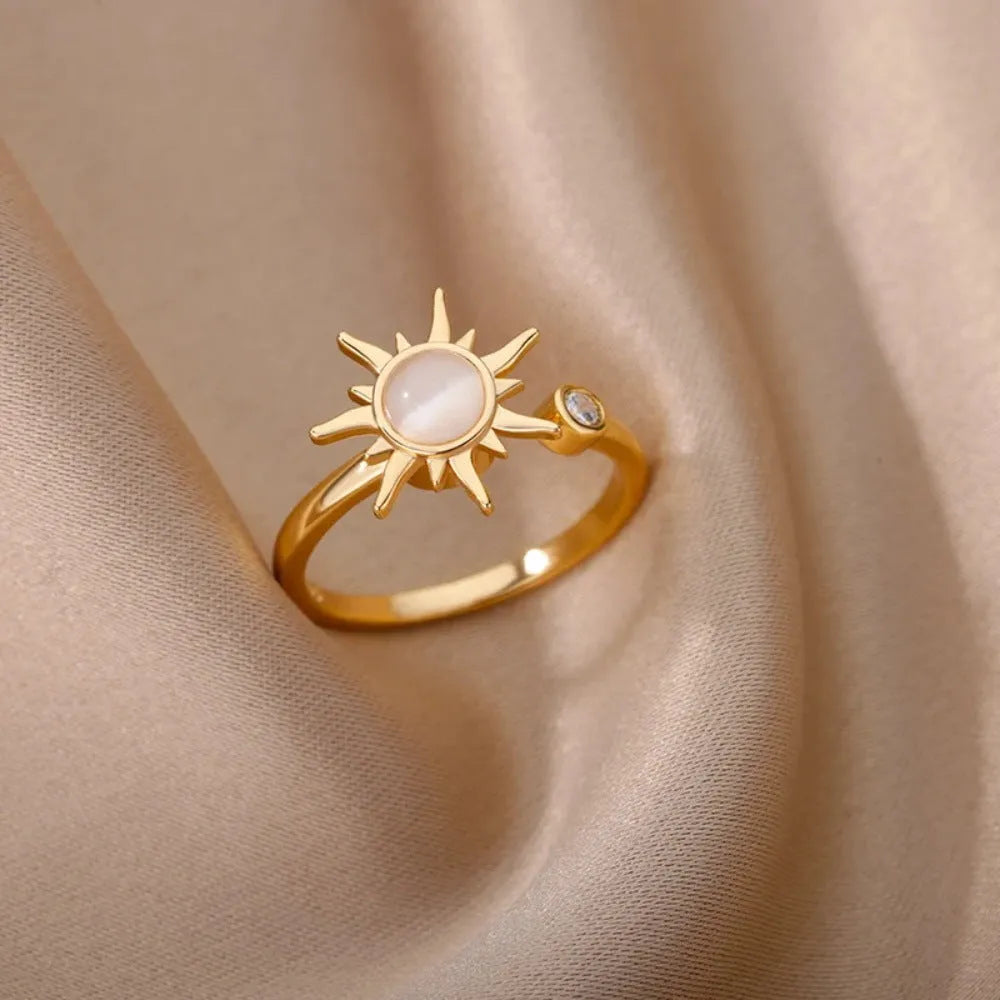 Adjustable rotating decompression ring in gold electroplated copper with geometric design