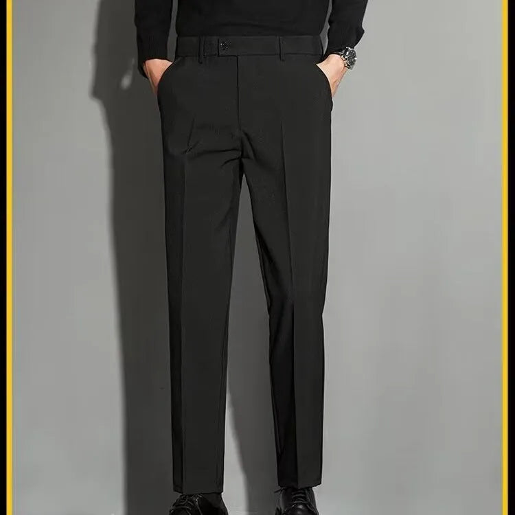 Men's straight-leg ankle-length suit trousers in a light colour showing drape and fit.